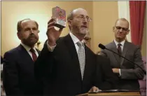  ?? RICH PEDRONCELL­I — THE ASSOCIATED PRESS ?? California state Sen. Steve Glazer, D-Orinda, displays a box of flavored e-liquid for vaping as he discusses his support for a measure by state Sen. Jerry Hill, D-San Mateo, left, to ban flavored tobacco products, during a news conference in 2019, in Sacramento. California voters can undo the 2020 law by voting for Prop. 31 on Nov. 8.