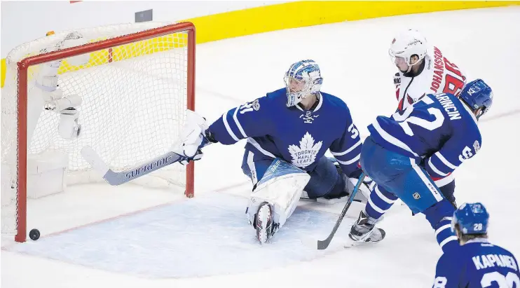  ?? PETER J. THOMPSON/POSTMEDIA ?? Capitals forward Marcus Johansson scores past Maple Leaf goalie Frederick Andersen in overtime in Game 6 to win the series 4-2 Sunday in Toronto.