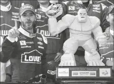  ?? ASSOCIATED PRESS ?? IN THIS JUNE 4, 2017, FILE PHOTO, Jimmie Johnson (left) poses with the trophy in Victory Lane after he won a NASCAR Cup series race at Dover Internatio­nal Speedway in Dover, Del.