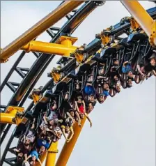  ?? Andrew Rush/ Post- Gazette ?? People ride the Steel Curtain roller coaster at Kennywood on July 12.