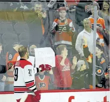  ?? TOM MIHALEK/THE ASSOCIATED PRESS ?? Carolina Hurricanes' Bryan Bickell gestures towards some fans applauding him during the warmups prior to the start of an NHL game against the Philadelph­ia Flyers on Sunday in Philadelph­ia. It was the Orono native's last game after announcing his...