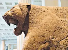  ??  ?? The fearsome profile of an Assyrian stone lion statue looms inside the British Museum