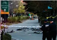  ?? AP PHOTO BY CRAIG RUTTLE ?? Bicycles and debris lie on a bike path after a motorist drove onto the path near the World Trade Center memorial, striking and killing several people Tuesday in New York.