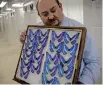  ?? BILL O’LEARY Washington Post ?? Floyd Shockley, an entomologi­st, holds butterfly specimens at the National Museum of Natural History in Washington.
