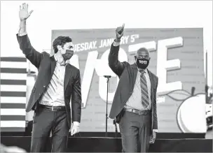  ?? DOUG MILLS/NEW YORK TIMES ?? From left, Democratic Senate candidates Jon Ossoff and the Rev. Raphael Warnock wave after a campaign event Monday with President-elect Joe Biden in Atlanta. Ossoff and Warnock were declared the winners of the Georgia Senate runoff races Wednesday.