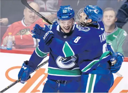  ?? DARRYL DYCK/THE CANADIAN PRESS ?? Brendan Gaunce and Chris Tanev celebrate Gaunce’s second goal against the Chicago Blackhawks on Thursday.