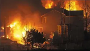  ?? ?? Overwhelme­d: Houses burning as wildfires rip through a neighbourh­ood in Superior, Colorado. — ap