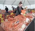  ?? JEFF CHIU/AP ?? San Francisco-Marin Food Bank volunteers pack food into bags to be delivered to the needy in California last year.