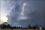  ?? RON JOHNSON — JOURNAL STAR VIA AP ?? Lightning flashes in storm clouds over the village of Dunlap, Ill., Tuesday. A spring-like storm churning across the Midwest poses a risk of more bad weather for millions of people.