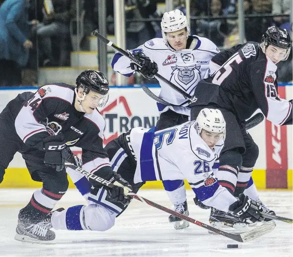  ?? — DARREN STONE/TIMES COLONIST FILES ?? Brayden Watts corrals the puck in front of a falling Andrei Grishakov of the Victoria Royals during the opening game of the Giants-Royals first-round WHL playoff series at the Save-on-Foods Memorial Centre in Victoria on Friday.