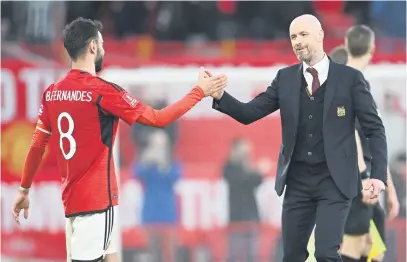  ?? Picture: AFP ?? ALL SMILES, Manchester United captain Bruno Fernandes (left) and manager Erik ten Hag celebrate after beating Liverpool in the quarterfin­als of the FA Cup at Old Trafford on Sunday.