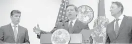  ?? AILEEN PERILLA/AP ?? Gov. Ron DeSantis, center, speaks as House Speaker Jose Oliva, left, R-Miami Lakes, left, and Senate President Bill Galvano, R-Bradenton, listen at a news conference Thursday.