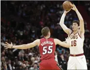  ?? WILFREDO LEE — THE ASSOCIATED PRESS ?? Cedi Osman passes past Heat guard Duncan Robinson during the first half Feb. 22in Miami. The Cavaliers lost, 124-105.