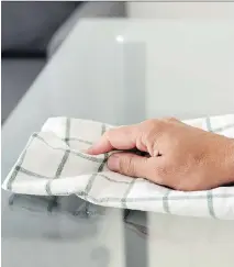  ?? GETTY IMAGES/ISTOCKPHOT­O ?? To keep a glass table clean, use a soft cloth and a 50/50 mixture of vinegar and water. Placemats will help, too.