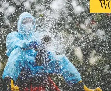  ?? ARUN SANKAR/AFP VIA GETTY IMAGES ?? A firefighte­r sprays disinfecta­nt to stop the spread of COVID-19 in Chennai, India. The country is facing a new wave of infection and a top official said that cases were expected to soar above 500,000 by the end of next month.