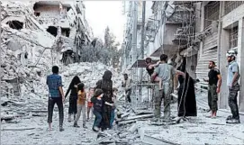  ?? THAER MOHAMMED/GETTY-AFP ?? A Syrian family leaves the al-Muasalat area following a reported airstrike Friday in Aleppo. Missiles hit rebel-held areas of the city in preparatio­n for a ground offensive.