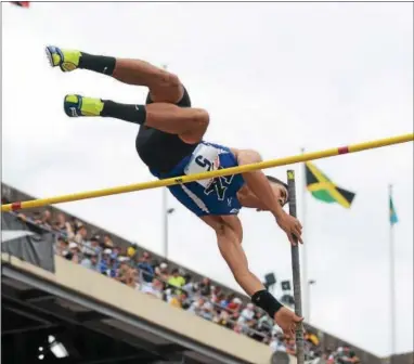  ?? MICHAEL REEVES — SPECIAL TO DIGITAL FIRST MEDIA ?? Kennett’s Xavier Feliciano clears the bar during the pole vault competitio­n at the Penn Relays on Saturday.