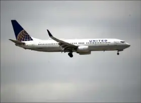  ?? David Zalubowski/Associated Press ?? A United Airlines jetliner lands April 9 at Denver Internatio­nal Airport. United announced Wednesday that despite receiving billions in federal aid, it may furlough nearly 36,000 employees on Oct. 1.