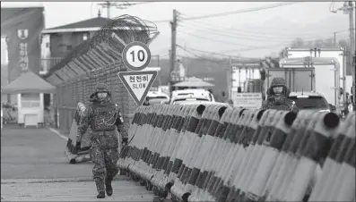  ?? AP/AHN YOUNG-JOON ?? South Korean soldiers patrol Unificatio­n Bridge near the border village of Panmunjom and the Kaesong industrial complex that South Korea had operated jointly with North Korea until Wednesday.