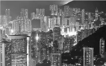  ??  ?? Illuminate­d residentia­l buildings seen from Victoria Peak in Hong Kong on Apr 6, 2016. — WP-Bloomberg photo