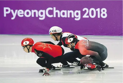  ?? ROBERTO SCHMIDT/AFP/GETTY IMAGES ?? China’s Wu Dajing, France’s Sebastien Lepape and Canada’s Charles Hamelin compete in a men’s 1,000-metre short-track speedskati­ng heat Tuesday at Gangneung Ice Arena. Hamelin and the 5,000-metre relay team, meanwhile, advanced Tuesday to the final.