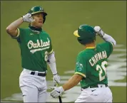  ?? BEN MARGOT — THE ASSOCIATED PRESS ?? The A’s Matt Chapman, right, receives congratula­tions from Mark Canha after homering against Arizona on Thursday.