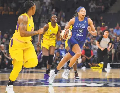  ?? Associated Press ?? The Minnesota Lynx’s Napheesa Collier (24) brings the ball up the court against the Los Angeles Sparks in June.