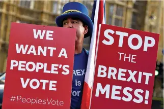  ?? REUTERS ?? AN ANTI-BREXIT DEMONSTRAT­OR holds placards outside the Houses of Parliament in London in this Nov. 13 photo.