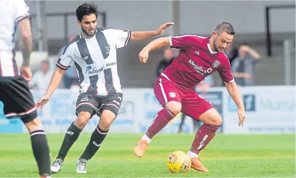  ?? Photograph by Darrell Benns ?? THE SOLUTION IS THERE IN BLACK AND WHITE: Elgin’s Rabin Omar in a challenge with Arbroath’s Ryan Wallace.