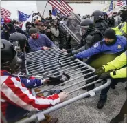  ?? ASSOCIATED PRESS FILE PHOTO ?? Rioters try to break through a police barrier at the Capitol in Washington on Jan. 6, 2021. News organizati­ons are using sophistica­ted new technologi­es to transform the way they conduct investigat­ions. Much of it is publicly available, or “open-source” material from mobile phones, satellite images and security cameras, but it also extends to computer modeling and artificial intelligen­ce. A reporting form that barely existed a decade ago is becoming an important part of journalism’s future.