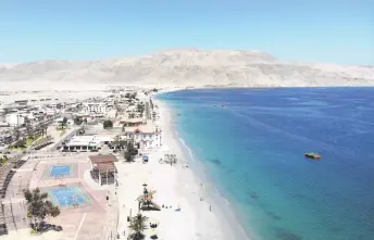  ?? ?? In this aerial view people enjoy the beach in Mejillones, Antofagast­a Region, Chile.