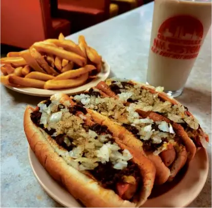  ?? GREG STEVENS ?? Now here’s a bona fide Rhode Island treat: hot wieners — a mixture of beef, pork, and veal — paired with fries and coffee milk, at Olneyville New York System in Providence.