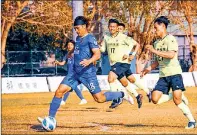  ?? PHOTO: SCREEN GRAB FROM TAICHUNG FUTURO’S FACEBOOK PAGE ?? Taichung Futuro striker Lee Mao, left, scores against TSG-Tainan as TSG defenders Chen Wen-jen, center, and Kim Sang-Jun look on in their Taiwan Football Premier League match in Tainan on Sunday.