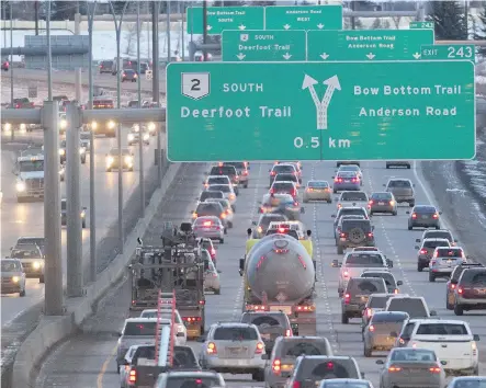  ?? CALGARY HERALD/ FILES ?? The tailights of evening rush hour traffic light up Deerfoot Trail South as it approaches the split for Anderson Road and Bow Bottom Trail.