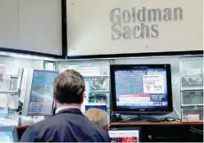  ?? — Reuters ?? Traders work inside the Goldman Sachs booth in New York Stock Exchange (NYSE) in New York.