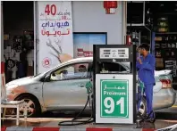  ?? AMR NABIL / ASSOCIATED PRESS ?? THE ATTACK A worker refuels Monday in Jiddah, Saudi Arabia. Global energy prices spiked Monday after a weekend attack on key oil facilities in Saudi Arabia caused the worst disruption to world supplies on record, an assault for which President Donald Trump warned the U.S. was “locked and loaded” to respond.