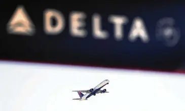  ?? DAVID GOLDMAN / AP 2017 ?? A Delta Air Lines flight takes off from Hartsfield-Jackson airport in Atlanta. Corporatio­ns are entitled to their own political opinions as citizens — let them speak for themselves, just like the rest of us, writes Clifford Humphrey.