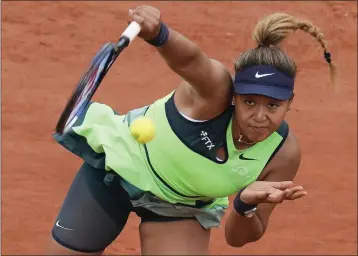  ?? CHRISTOPHE ENA ?? Naomi Osaka serves during her 7-5, 6-4loss to Amanda Anisimova in the first round of the French Open on Monday.