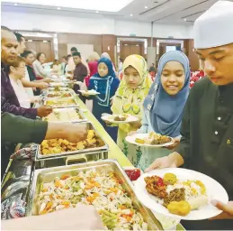 ?? PIC COURTESY OF BERJAYA ?? The children enjoying a sumptuous spread during the event. –