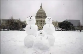  ?? ALEX BRANDON—ASSOCIATED PRESS ?? A snow family is seen on Capitol Hill as a winter storm arrives in the region, Sunday, Jan. 13, 2019, in Washington.