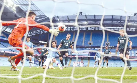  ?? - AFP photo ?? Midfielder David Silva scores the fourth goal past Burnley's English goalkeeper Nick Pope during the English Premier League football match between Manchester City and Burnley at the Etihad Stadium in Manchester.