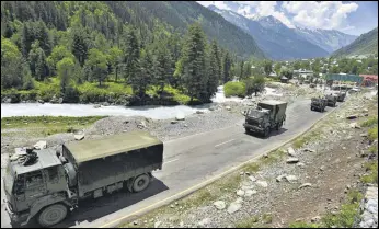  ??  ?? An Indian Army convoy moves along a highway leading to Ladakh, at Gagangeer in Ganderbal district of Jammu and Kashmir on Wednesday. WASEEM ANDRABI/HT