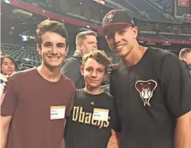  ?? DAN BICKLEY/AZCENTRAL SPORTS ?? Tyler Dispenzier­e (left) meets his favorite player, Jake Lamb (right), with Cameron Bickley.