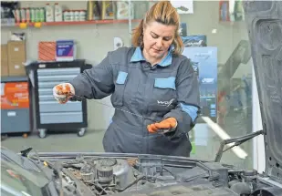  ?? HALWEST ABDULKAREE­M ?? In a male-dominated auto-repair industry, Shadi Mohammed opened a garage staffed by women.