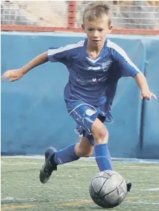  ??  ?? Edward Cozens, the grandson of former Posh skipper John Cozens, in action , in blue obviously! The 10 year-old is attracting the attention of some profession­al clubs.