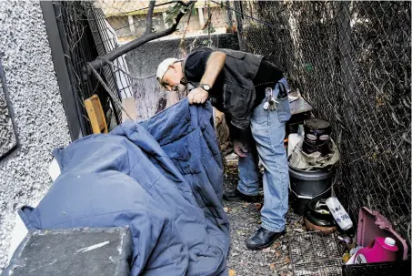  ?? Brant Ward / The Chronicle ?? Jason Albertson, psychiatri­c social worker on the Homeless Outreach Team, checks a homeless encampment in Bayview.