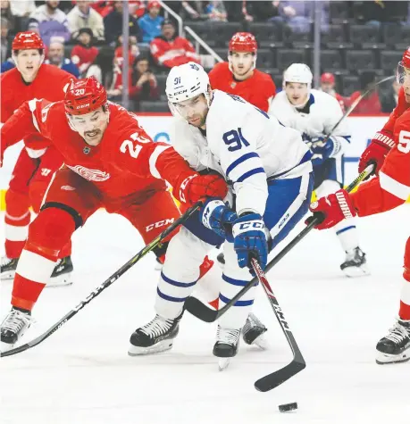  ??  ?? Leafs centre John Tavares battles for the puck against Wings defenceman Dylan Mcilrath Wednesday in Detroit.
TIM FULLER/USA TODAY SPORTS