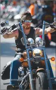  ?? NWA Democrat-Gazette/ANDY SHUPE ?? A motorcycli­st rides Saturday along Dickson Street during the annual Bikes, Blues & BBQ Motorcycle Rally in Fayettevil­le.