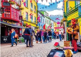  ??  ?? QUIRKY: Some of the brightly coloured bars and shops in Galway