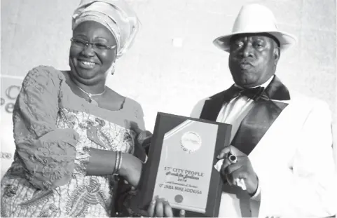  ??  ?? Lagos State First Lady Dame Abimbola Emanuella Fashola (Left) presenting the Grand Commander of Business award to Globacom Chairman Dr. Mike Adenuga, represente­d by Director, M. A Group, Mr. Niyi Adewunmi, at the City People 17th Annual Awards for...